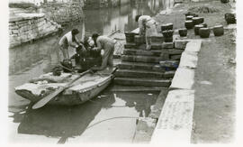 [People working on a boat]